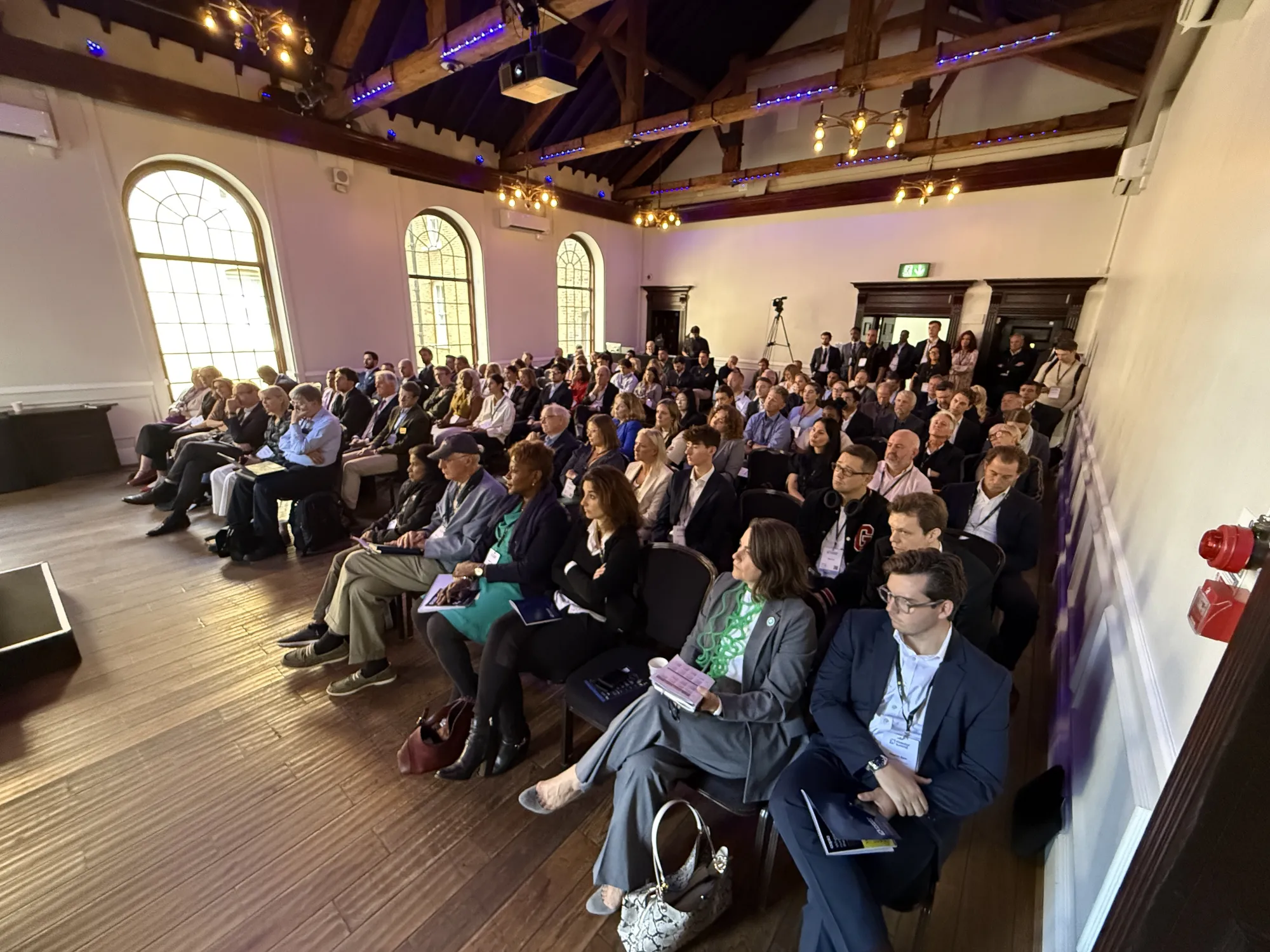 Delegates seated in the breakout room watching a session