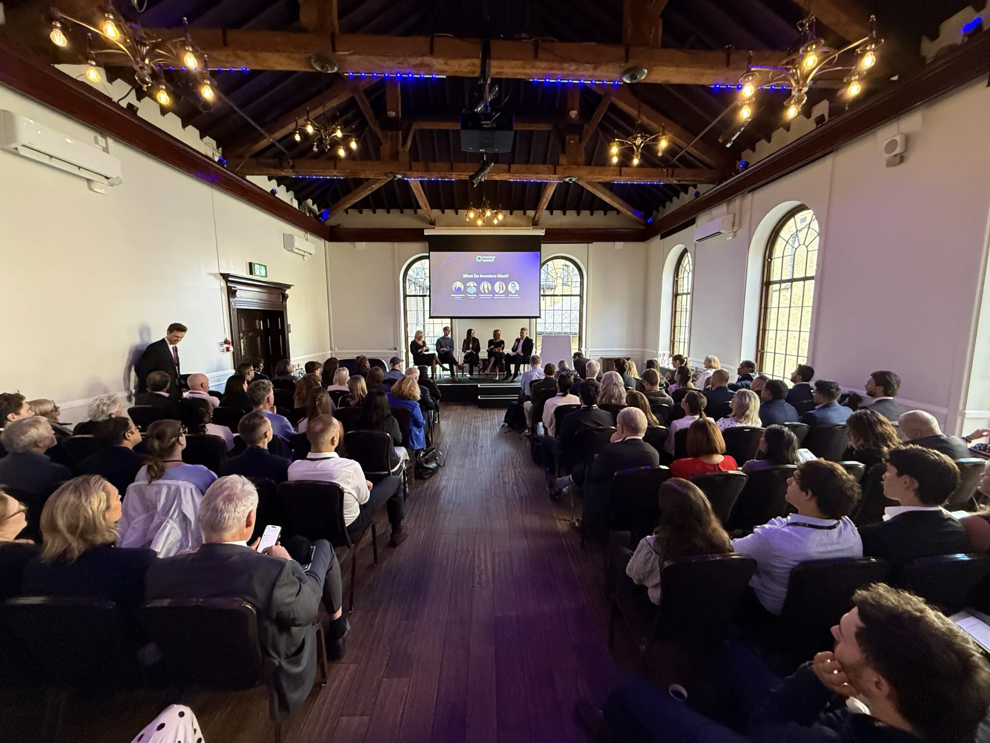 A packed breakout room during a panel session